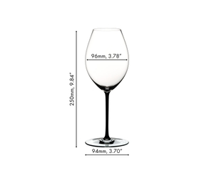 A RIEDEL Fatto A Mano Syrah glass in black filled with red wine on a white background. 