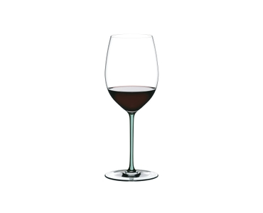 A RIEDEL Fatto A Mano Cabernet/Merlot glass in mint filled with red wine on a transparent background. 