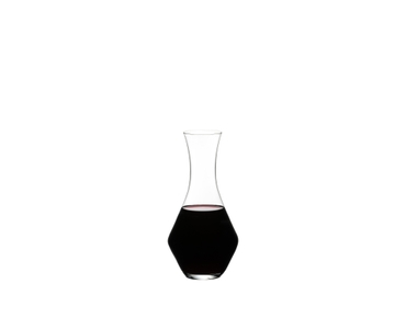 RIEDEL Merlot Decanter filled with a drink on a white background