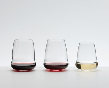 A SL RIEDEL Stemless Wings Cabernet/Merlot glass filled with red wine on a white background. 