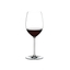 A RIEDEL Fatto A Mano Cabernet/Merlot glass in white filled with red wine on a transparent background. 
