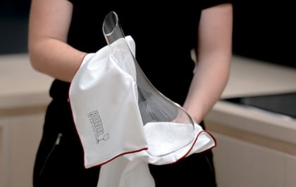 a Riedel decanter is cleaned with a Riedel microfiber cloth