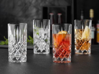 NACHTMANN Noblesse longdrink glasses, three of them filled with cocktail drinks on ice and one is empty.<br/>
