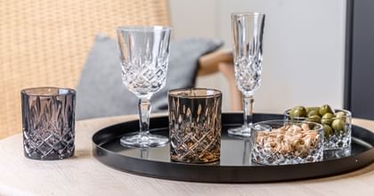 NACHTMANN Noblesse Series on a table top with nuts and olives.
