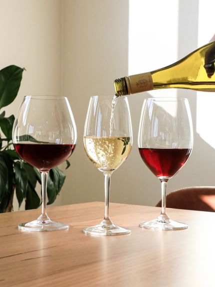 Three filled NACHTMANN Vivino wine glasses on a table