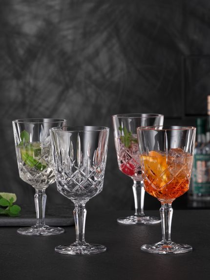 <br/>Four NACHTMANN Noblesse cocktail glasses, three of them filled with different Spritz cocktails, one is empty.<br/>
