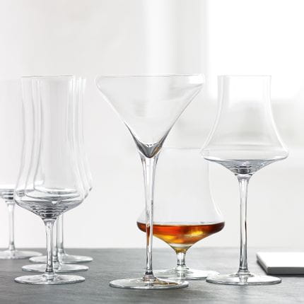 The empty SPIEGELAU Willsberger Anniversary Martini glass and Digestive glass and behind them the filled SPIEGELAU Willsberger Anniversary Whisky glass.<br/>