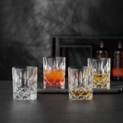 NACHTMANN Noblesse tumblers, one of them filled with Whisky. Two are filled with drinks on ice and one is empty.<br/>
