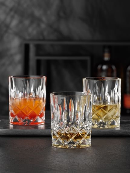 NACHTMANN Noblesse tumblers, one of them filled with Whisky. Two are filled with drinks on ice and one is empty.<br/>